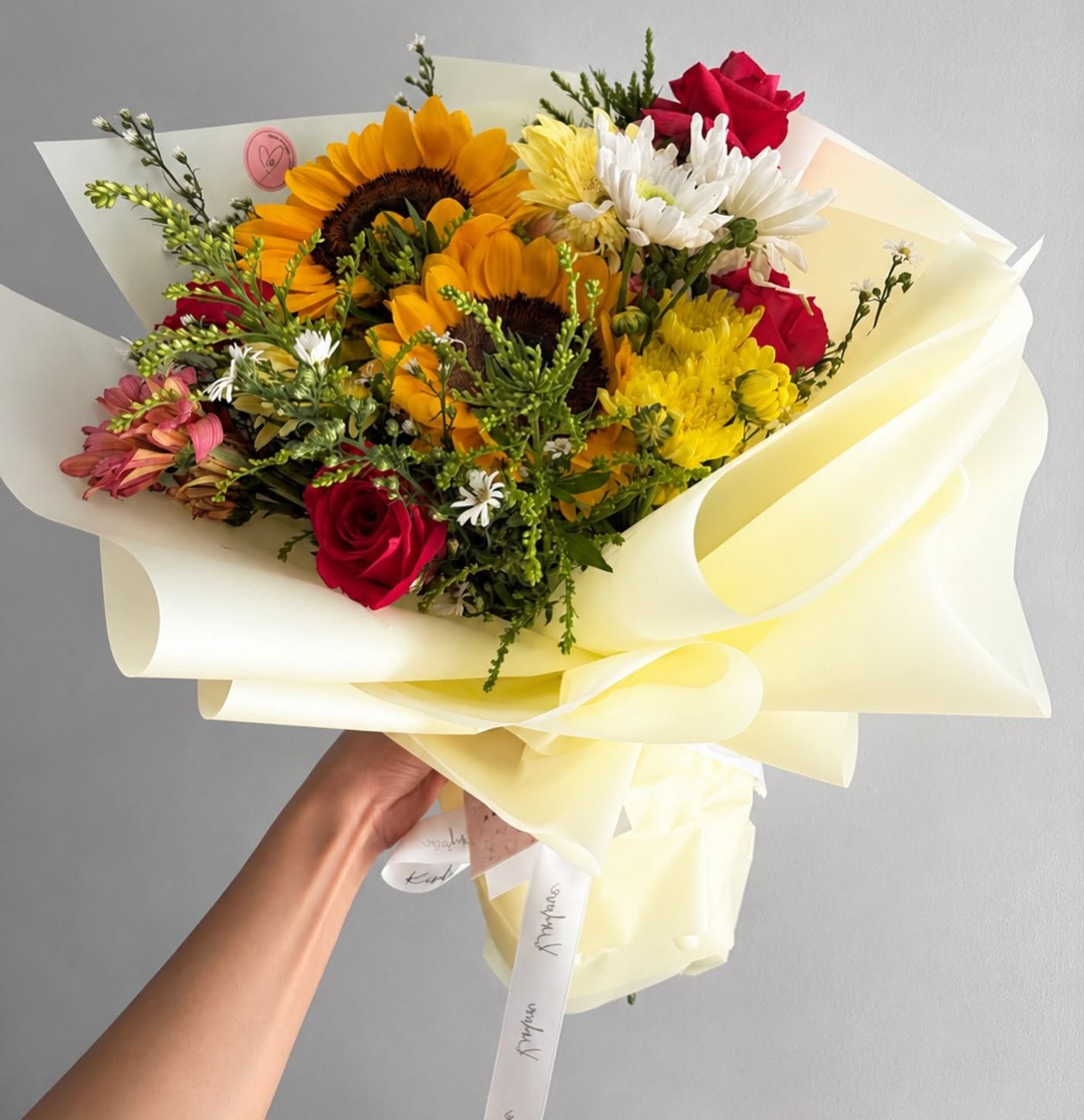 Sunflower and rose bouquet in hand